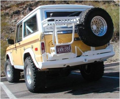 A yellow and white jeep with a tire on the back